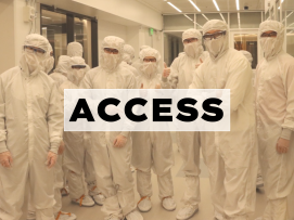 A photo of people wearing bunnysuits inside a cleanroom