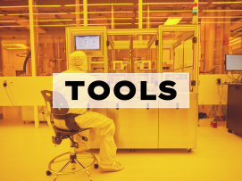 A person uses a tool in the cleanroom
